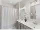 Bright bathroom with a double sink vanity, two mirrors with vanity lighting, and a shower tub at 3212 Ashwell Oaks Ln, Matthews, NC 28105