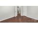 A brightly lit bedroom boasts attractive wood floors and neutral colored walls at 3212 Ashwell Oaks Ln, Matthews, NC 28105