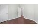 Spacious bedroom features hardwood floors, neutral paint, and interior door to other rooms at 3212 Ashwell Oaks Ln, Matthews, NC 28105
