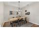 Elegant dining room with stylish chandelier, decor, and seating for six at 3212 Ashwell Oaks Ln, Matthews, NC 28105