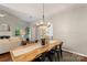 Dining area with hardwood floors, view into the living room, and modern decor at 3212 Ashwell Oaks Ln, Matthews, NC 28105