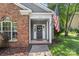 Inviting home exterior showcasing brick, stylish front door with wreath, and American flag at 3212 Ashwell Oaks Ln, Matthews, NC 28105