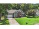 Well-maintained home with a brick facade, lush lawn, and mature trees at 3212 Ashwell Oaks Ln, Matthews, NC 28105