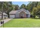 Charming home with brick accents, lush lawn, and mature trees at 3212 Ashwell Oaks Ln, Matthews, NC 28105