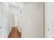 Hallway with hardwood floors and white walls at 3212 Ashwell Oaks Ln, Matthews, NC 28105