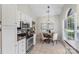 Eat-in kitchen featuring stainless steel appliances, white cabinets, and a pendant light fixture at 3212 Ashwell Oaks Ln, Matthews, NC 28105