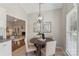 Eat-in kitchen featuring an elegant pendant light and access to the living room at 3212 Ashwell Oaks Ln, Matthews, NC 28105