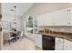 Eat-in kitchen featuring white cabinets and stainless steel appliances at 3212 Ashwell Oaks Ln, Matthews, NC 28105