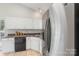 Bright kitchen featuring stainless steel refrigerator and white cabinets at 3212 Ashwell Oaks Ln, Matthews, NC 28105