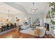 Spacious living room features hardwood floors, and adjacent dining area, perfect for entertaining at 3212 Ashwell Oaks Ln, Matthews, NC 28105