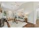Open-concept living room featuring hardwood floors, neutral decor, and a view into the dining area at 3212 Ashwell Oaks Ln, Matthews, NC 28105