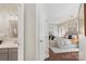 Bedroom with ensuite bathroom featuring hardwood floors and modern decor at 3212 Ashwell Oaks Ln, Matthews, NC 28105