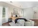 Inviting main bedroom featuring a decorative metal headboard, wood floors, and an abundance of natural light at 3212 Ashwell Oaks Ln, Matthews, NC 28105