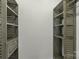 Walk-in closet with built-in shelving and a drawer for organizing clothes and accessories at 3212 Ashwell Oaks Ln, Matthews, NC 28105
