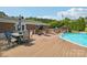 A home's backyard with pool, patio, table, umbrella, and lots of seating at 327 Johnson Dairy Rd, Mooresville, NC 28115