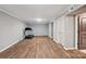Finished basement area with hardwood floors, a treadmill, and a doorway at 327 Johnson Dairy Rd, Mooresville, NC 28115