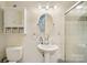 Small bathroom features a shower, white vanity, decorative mirror and ample lighting at 327 Johnson Dairy Rd, Mooresville, NC 28115