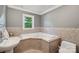 Cozy bathroom features a corner tub, neutral tile and lighting near a pedestal sink and toilet at 327 Johnson Dairy Rd, Mooresville, NC 28115