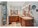 Bathroom with dual sinks, granite countertops, wood cabinets, tile floors, and a walk-in shower at 327 Johnson Dairy Rd, Mooresville, NC 28115