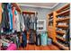 Walk-in closet with wooden cabinets, shelves, drawers, and ample storage space for clothes and shoes at 327 Johnson Dairy Rd, Mooresville, NC 28115