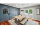 Dining area with a large table and wooden bench seating next to the pool entrance at 327 Johnson Dairy Rd, Mooresville, NC 28115