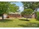 Charming brick home with a well-manicured front yard and mature trees, offering great curb appeal at 327 Johnson Dairy Rd, Mooresville, NC 28115