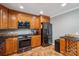 Modern kitchen with stainless steel appliances, granite countertops, and warm wood cabinetry at 327 Johnson Dairy Rd, Mooresville, NC 28115