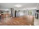 Open-concept living room boasts hardwood floors, whitewashed fireplace, and outdoor access at 327 Johnson Dairy Rd, Mooresville, NC 28115