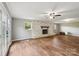 Bright living room with whitewashed fireplace and large windows offering natural light at 327 Johnson Dairy Rd, Mooresville, NC 28115