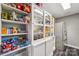 Well-stocked pantry features ample shelving and storage space next to a stainless steel refrigerator at 327 Johnson Dairy Rd, Mooresville, NC 28115