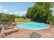 Outdoor pool area with wood deck, surrounded by lush greenery and seating at 327 Johnson Dairy Rd, Mooresville, NC 28115