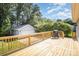 Spacious backyard deck with lush greenery and an outdoor grill at 3427 Wonderland Dr, Matthews, NC 28104