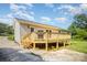 Home with an elevated wooden deck and lush grass and plant groundcover at 3427 Wonderland Dr, Matthews, NC 28104