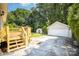Exterior view featuring a spacious backyard, deck, and detached garage with a concrete driveway at 3427 Wonderland Dr, Matthews, NC 28104
