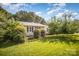 Exterior of a charming single-story home with luscious green yard and mature trees at 3427 Wonderland Dr, Matthews, NC 28104