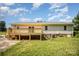 Back exterior of home featuring a new deck and lush backyard at 3427 Wonderland Dr, Matthews, NC 28104
