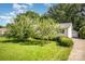 Charming ranch-style home with a lush, green lawn and mature trees in a desirable neighborhood at 3427 Wonderland Dr, Matthews, NC 28104