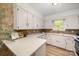 A classic kitchen with white cabinetry and updated countertops offers ample space for cooking and storage at 3427 Wonderland Dr, Matthews, NC 28104