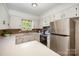 A bright kitchen with stainless steel appliances and quartz countertops exudes cleanliness and efficiency at 3427 Wonderland Dr, Matthews, NC 28104