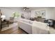 Bright living room with wood floors, ceiling fan, and neutral-colored sofa and chairs at 3427 Wonderland Dr, Matthews, NC 28104