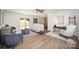 Spacious living room featuring a back deck view, light hardwood floors, and designer decor at 3427 Wonderland Dr, Matthews, NC 28104