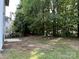 Large backyard with mature trees and lush green grass provides a private outdoor retreat at 3617 Betterton Ln, Charlotte, NC 28269