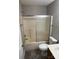 Bathroom with tile flooring, bathtub and shower combination with sliding glass door at 3617 Betterton Ln, Charlotte, NC 28269