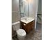 Well-lit bathroom featuring modern vanity, toilet, and access to hall at 3617 Betterton Ln, Charlotte, NC 28269