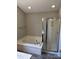 Bathroom with a soaking tub and glass enclosed shower at 3617 Betterton Ln, Charlotte, NC 28269