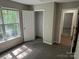 Comfortable bedroom with a large window, closet, and neutral carpeting at 3617 Betterton Ln, Charlotte, NC 28269