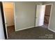 Bedroom featuring neutral carpeting with walk-in closet and easy access to the upstairs hallway at 3617 Betterton Ln, Charlotte, NC 28269