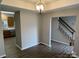 Open dining space with views of the kitchen and a staircase, featuring warm neutral colors at 3617 Betterton Ln, Charlotte, NC 28269