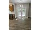 Bright dining area with hardwood floors, double doors to backyard, and modern light fixture at 3617 Betterton Ln, Charlotte, NC 28269