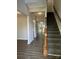 Bright foyer showcases a staircase with wood railing, neutral walls, and hardwood floors at 3617 Betterton Ln, Charlotte, NC 28269